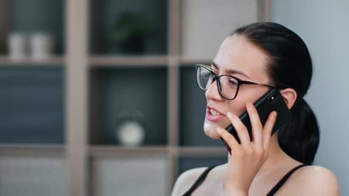 Young Woman Chatting on Cell Phone in Home