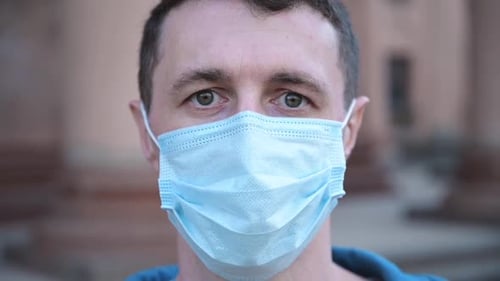 Close Up Portrait of a Young Man Wearing Protective Mask on Street
