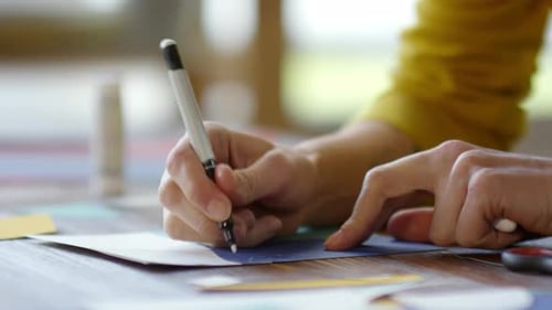 Hands Drawing on Paper with Marker