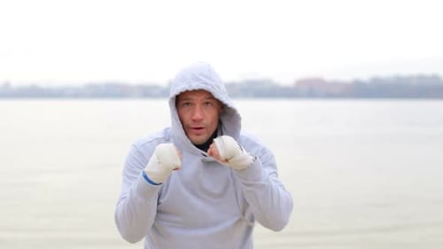 Man Boxing and Training Outdoors