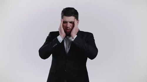 Young Man Having Headache Studio Portrait