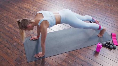 Woman Exercising with Resistance Band in Home