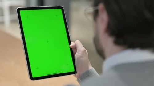 Man Using Tablet with Green Chroma Screen