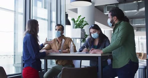 Business Team Collaborating During Pandemic at Table