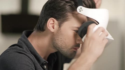 Serious Man Putting Virtual Goggles at Home. Closeup Man Face in Vr.