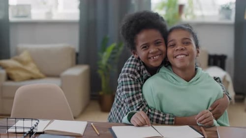 Smiling Children Embracing in Sunny Home Environment