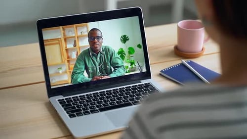 Woman Video Calling Man on Laptop in Office