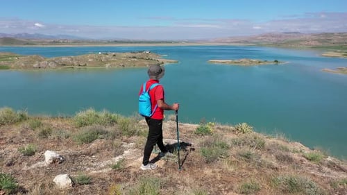 Trekker Watching The Lake