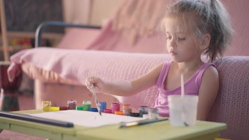 Little Girl Painting Indoors at Table