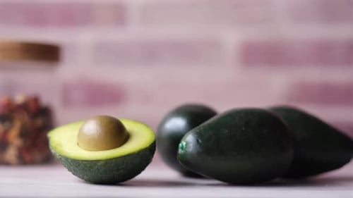 Close Up of Slice of Avocado and Mixed Nut on Chopping Board