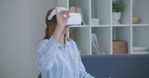 Woman Experiencing Virtual Reality with Headset Indoors