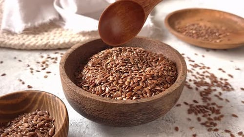 Brown flax seeds in a bowl close up