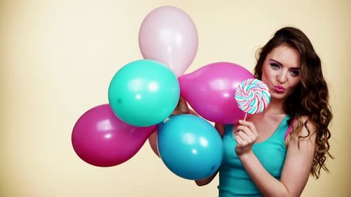 Happy Woman Posing with Balloons and Lollipop