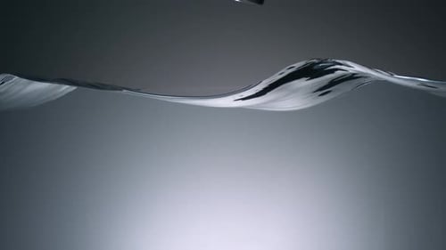 Glass Bottle Dropping into Splashing Water