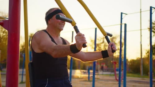 Old Man Exercising in and Outdoor Gym