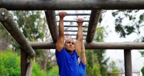 Man and Woman Exercising on Outdoor Obstacle Course