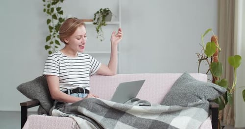 Woman Video Chatting on Laptop at Home