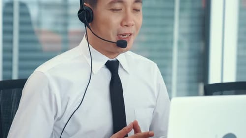 Businessman Wearing Headset Working Actively in Office