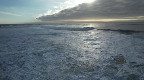 Ocean Waves Crashing to the Shore at Sunrise
