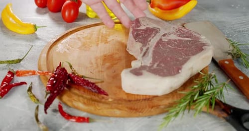 Preparing raw meat steak cuts for cooking