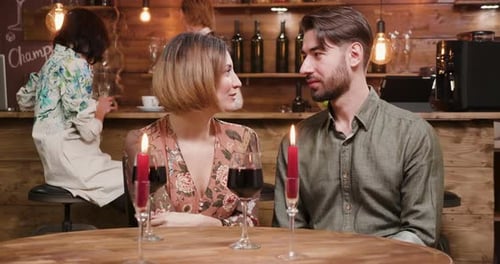 A Young Couple Celebrating Their Anniversary in a Small Restaurant