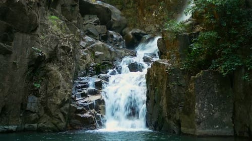 Scenic Waterfall Cascading Through Rocky Landscape