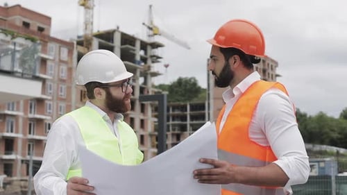 Male Construction Engineer Discussion with Architect at Construction Site or Building Site