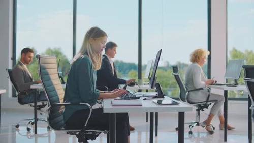 People Working on Computers in Modern Bright Office