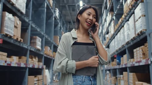 Businesswoman online seller talk confirming orders from customer on phone in shopping center