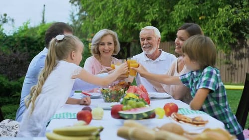 Cheerful Multi-Generational Family Having Picnic Outdoors