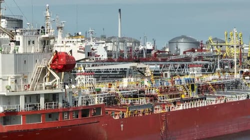 Liquid Cargo Transporter Ships Unloading Crude Oil to a Fuel Depot