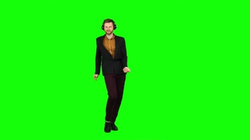 Guy Listens To Energetic Music in Headphones and Dances. Green Screen