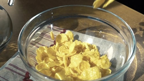 Cereal Flakes Pouring Into Glass Breakfast Bowl
