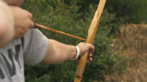 Man Shoots an Arrow