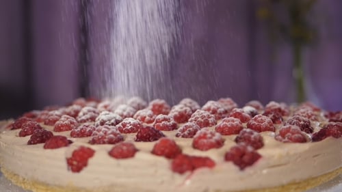 Pouring Sugar Powder on a Cake