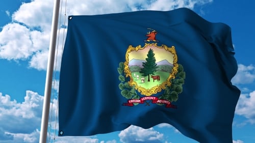 Realistic Waving Vermont State Flag with Emblem Against Blue Sky