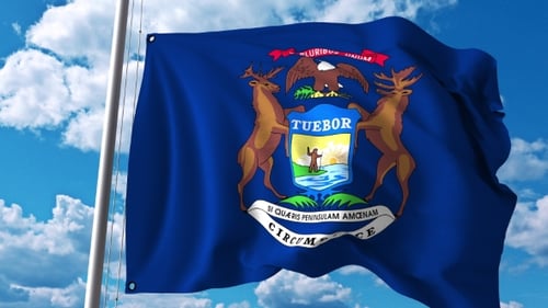 Realistic Waving Michigan State Flag with Blue Sky