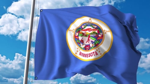 Waving Minnesota State Flag Against Blue Sky