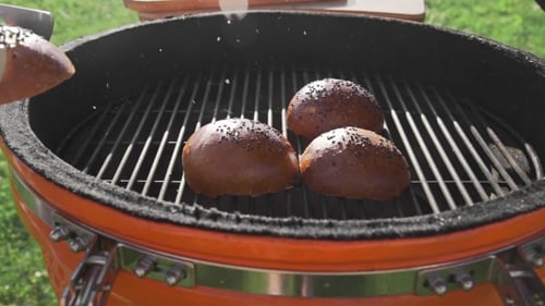 Crispy Buns Are Roasting on the Grill in the Sunny Summer Day, Cooking Food on the Open Fire, the