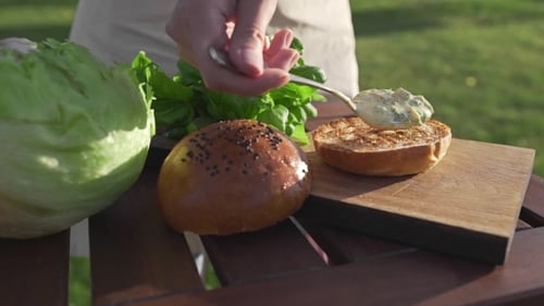 Preparing Delicious Hamburger with Fresh Ingredients Outdoors