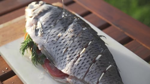 Raw Carp Is Prinkling with Olive Oil for Being Grilled, Preparations for the Barbecue, Cooking Fish