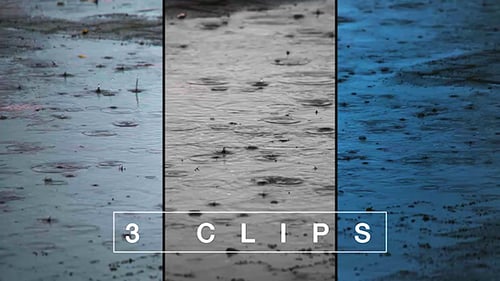 Close up of rain drops in water puddle