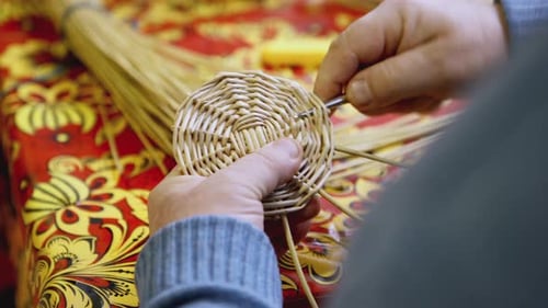 Weaving Straw Basket on Red Painted Table