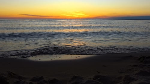 Sea Waves Rolling On A Empty Sandy Beach