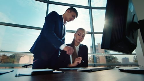 Business Partners Work Together in a Large Bright and Modern Office