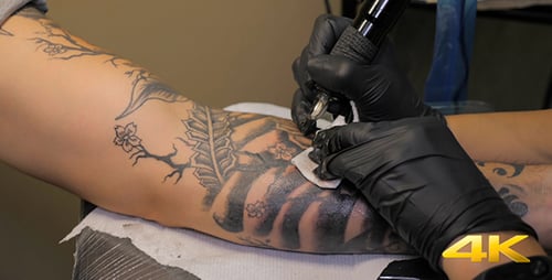 Tattoo Artist Creates Tattoo on Person's Arm