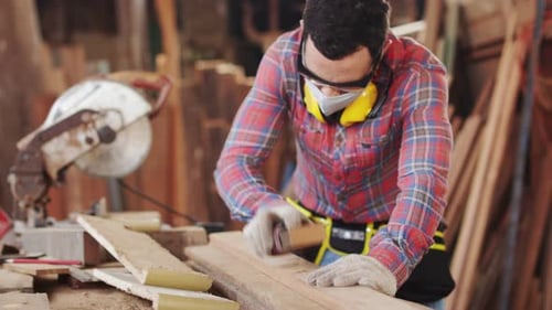 Man Sanding Wood in Workshop