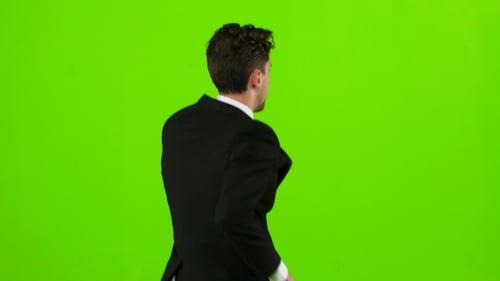 Man Is a Telephone Rings To Him and He Talks. Green Screen