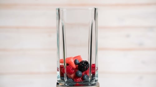 Fresh Berries Falling into a Glass