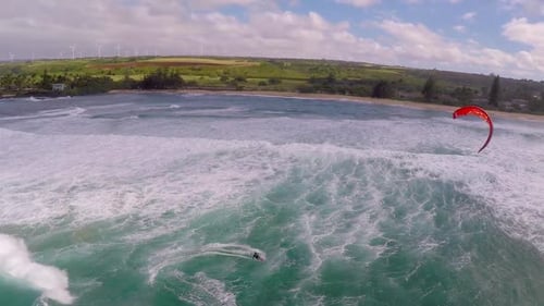 Aerial view of a man kitesurfing in Hawaii
